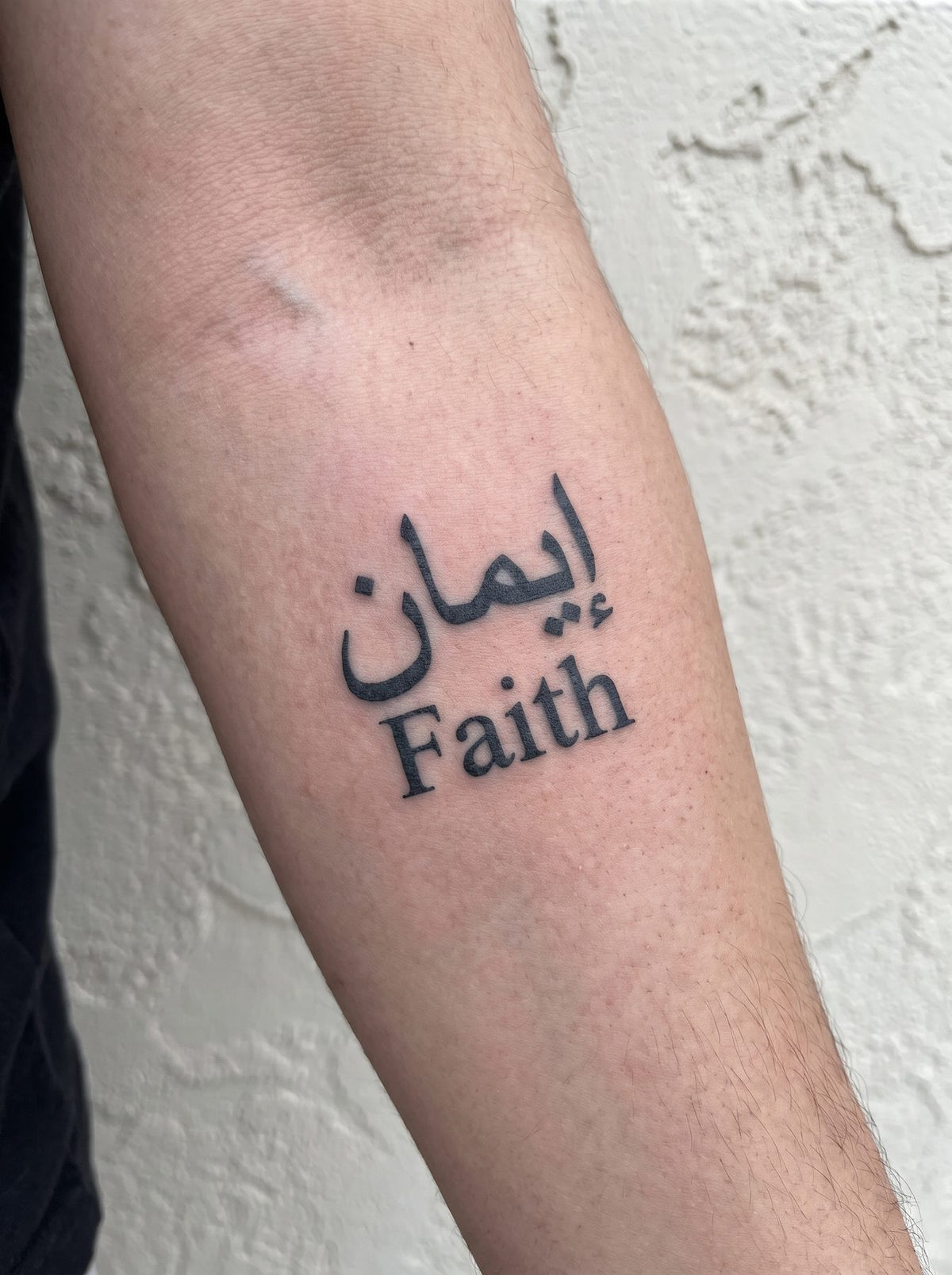 Faith temporary tattoo shown on a forearm