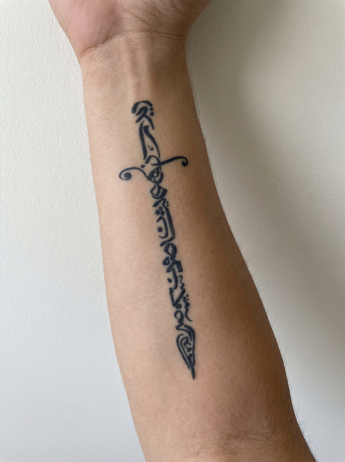 Sword temporary tattoo shown on a forearm