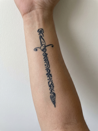 Sword temporary tattoo shown on a forearm