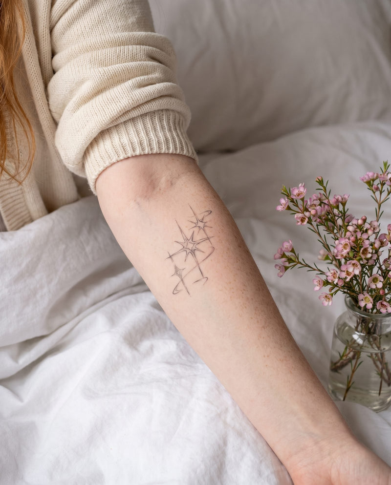 Sparkles semi-permanent tattoo on inner forearm