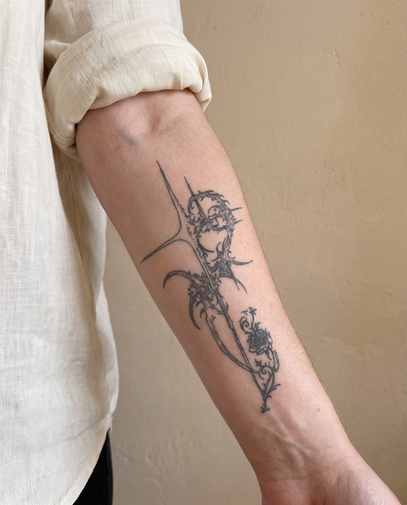 Thorn Rose Cross semi-permanent tattoo on inner forearm