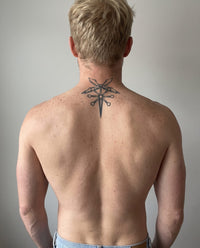 Winged Staff semi-permanent tattoo on back of neck